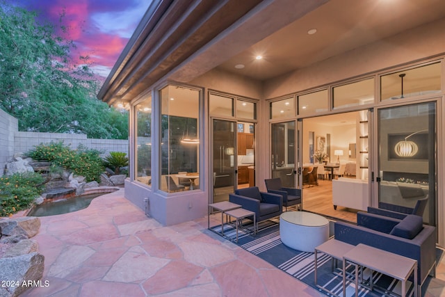 view of patio terrace at dusk