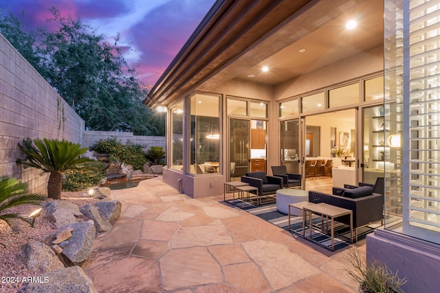 view of patio terrace at dusk