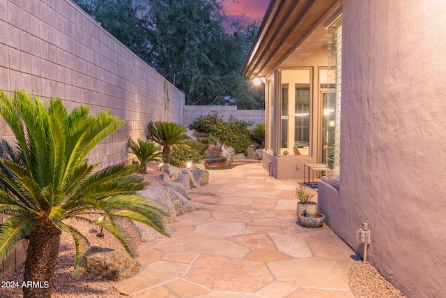 view of patio terrace at dusk