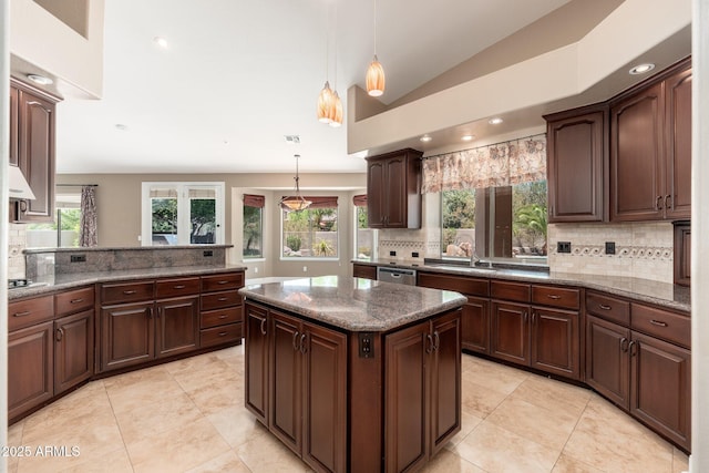 12120 E Cortez Dr, Scottsdale, AZ 85259 - kitchen with decorative backsplash, appliances with stainless steel finishes, dark stone counters, decorative light fixtures, and dark brown cabinets