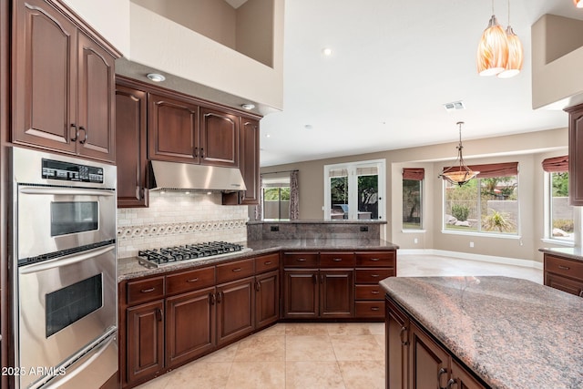 12120 E Cortez Dr, Scottsdale, AZ 85259 - kitchen with appliances with stainless steel finishes, a warming drawer, under cabinet range hood, decorative backsplash, and healthy amount of natural light