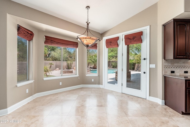 12120 E Cortez Dr, Scottsdale, AZ 85259 - unfurnished dining area featuring vaulted ceiling, healthy amount of natural light, and light tile patterned flooring