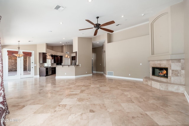 12120 E Cortez Dr, Scottsdale, AZ 85259 - unfurnished living room featuring ceiling fan, a tile fireplace, and recessed lighting