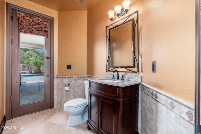 12120 E Cortez Dr, Scottsdale, AZ 85259 - bathroom featuring tile walls, tile patterned floors, vanity, and wainscoting