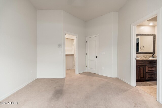 12120 E Cortez Dr, Scottsdale, AZ 85259 - unfurnished bedroom with light carpet, a spacious closet, ensuite bathroom, and a closet
