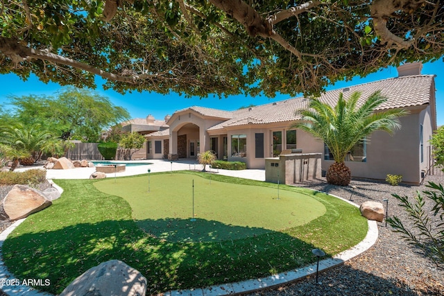 12120 E Cortez Dr, Scottsdale, AZ 85259 - fenced backyard featuring a putting area, a patio area, and a jacuzzi