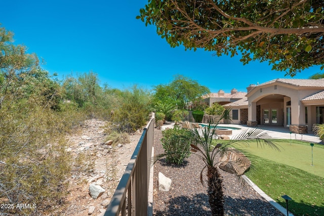 12120 E Cortez Dr, Scottsdale, AZ 85259 - view of yard with french doors, a putting area, and a patio area