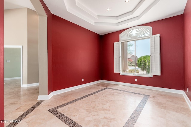 12120 E Cortez Dr, Scottsdale, AZ 85259 - empty room featuring a raised ceiling, plenty of natural light, arched walkways, and recessed lighting