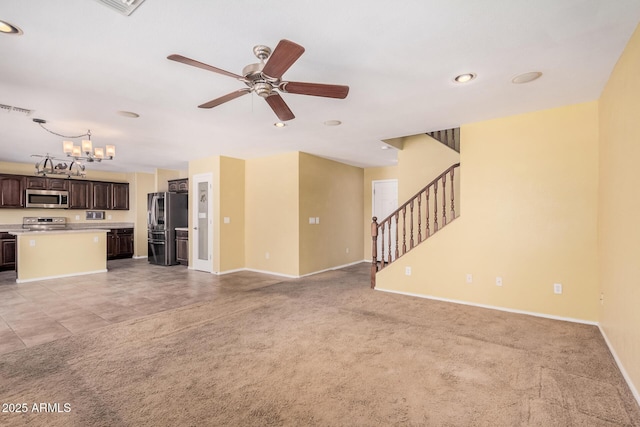 22123 E Via Del Palo, Queen Creek, AZ 85142 - unfurnished living room featuring baseboards, visible vents, light carpet, and ceiling fan with notable chandelier