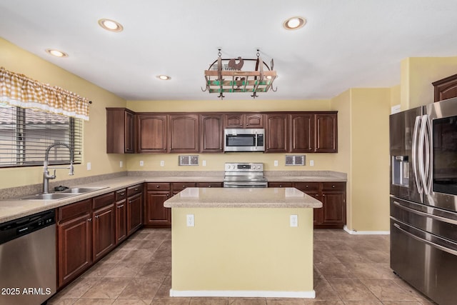 22123 E Via Del Palo, Queen Creek, AZ 85142 - kitchen with dark brown cabinetry, a kitchen island, light countertops, a sink, and stainless steel appliances