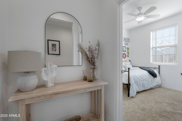 bedroom featuring light carpet and baseboards