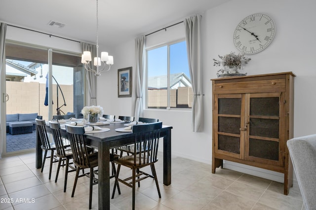 dining area with light tile patterned floors, baseboards, visible vents, and an inviting chandelier