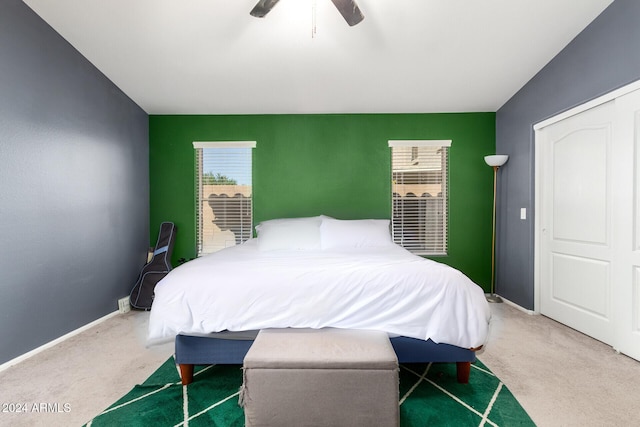 carpeted bedroom with a closet and ceiling fan