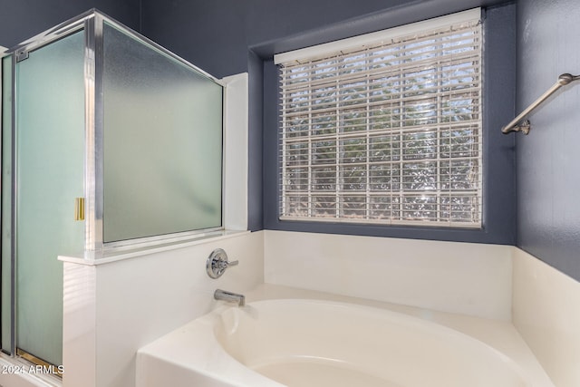 bathroom with separate shower and tub