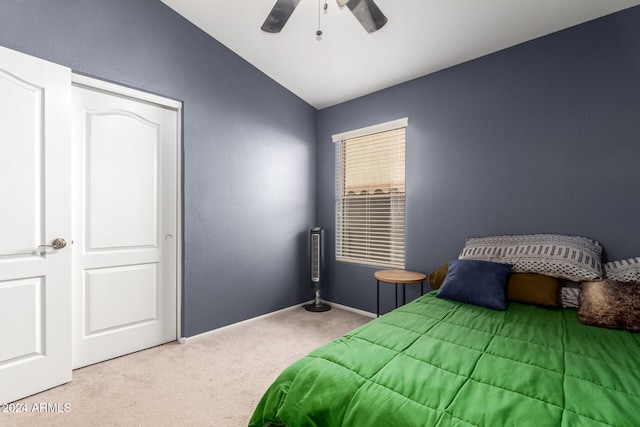 carpeted bedroom with ceiling fan and vaulted ceiling