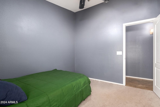 bedroom with ceiling fan and light colored carpet