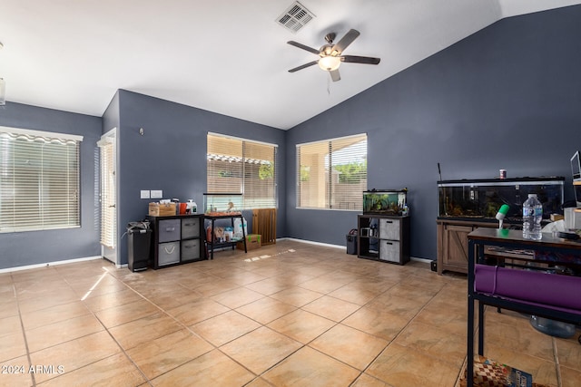 tiled living room featuring ceiling fan and vaulted ceiling