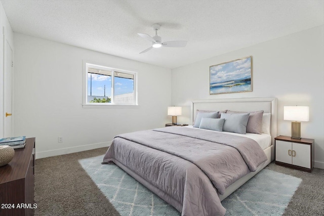 carpeted bedroom with a textured ceiling and ceiling fan