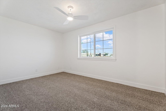 carpeted spare room with a textured ceiling and ceiling fan