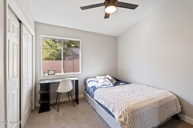 carpeted bedroom featuring a closet and ceiling fan