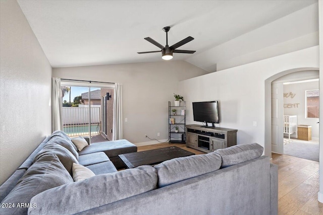 living room featuring light wood-type flooring, ceiling fan, and vaulted ceiling