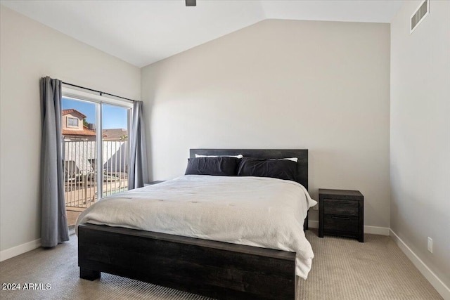 bedroom with access to outside, light colored carpet, and vaulted ceiling