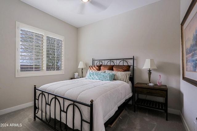 bedroom with ceiling fan and dark carpet