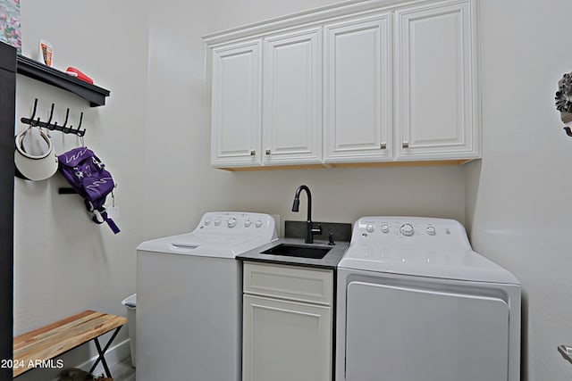 laundry area featuring cabinets, sink, and washer and dryer