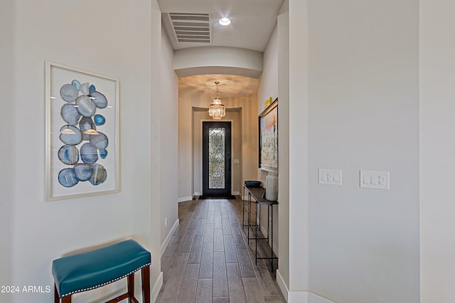 interior space with a chandelier and hardwood / wood-style floors