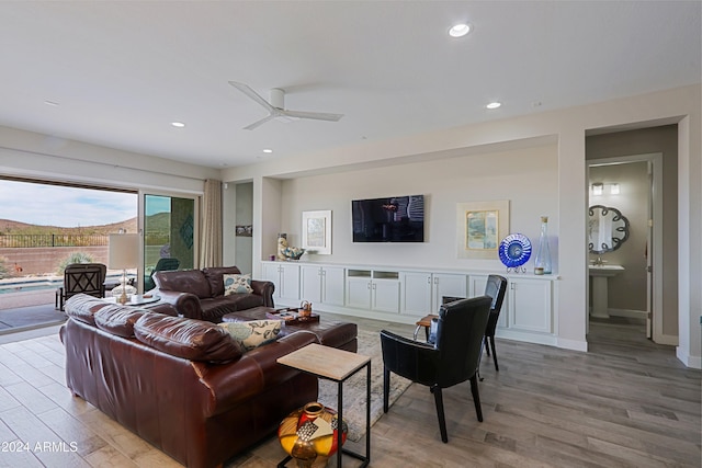 living room with light wood-type flooring and ceiling fan