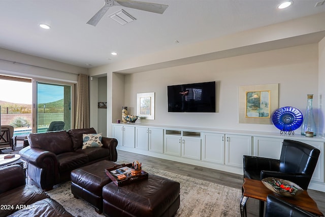 living room with light wood-type flooring and ceiling fan