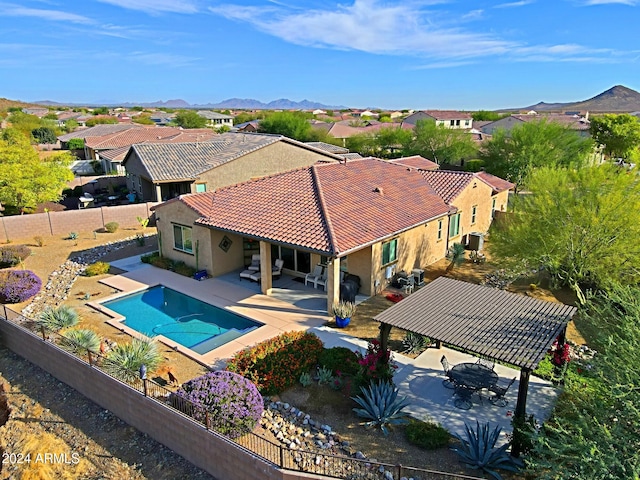 view of pool with a gazebo, a mountain view, and a patio