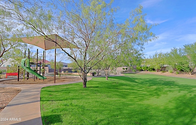 view of property's community featuring a yard and a playground