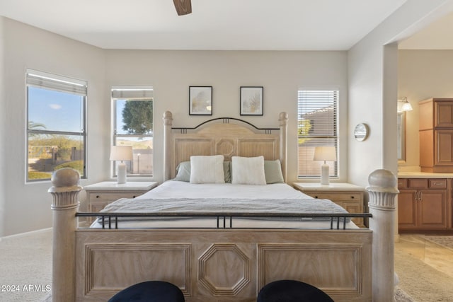 bedroom featuring connected bathroom and ceiling fan