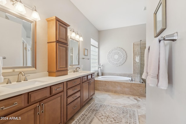 bathroom featuring vanity and tiled bath