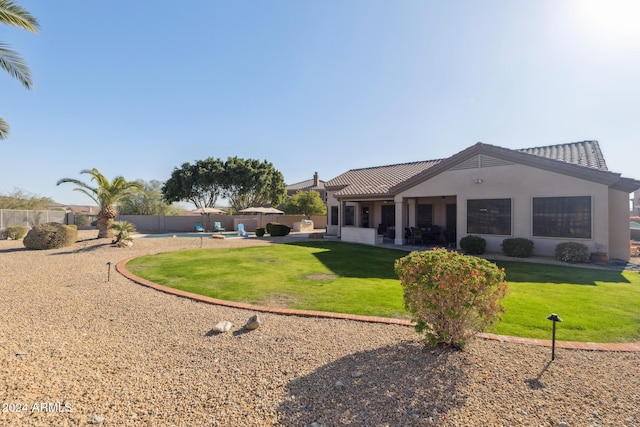 exterior space featuring a front lawn and a patio