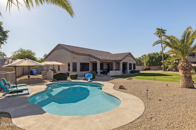 view of pool with a yard and a patio