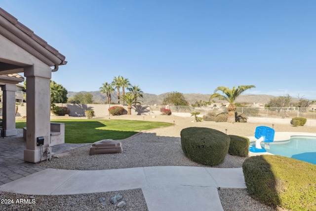 view of yard featuring a fenced in pool and a mountain view