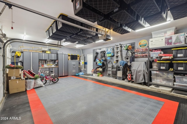 garage featuring a garage door opener and water heater