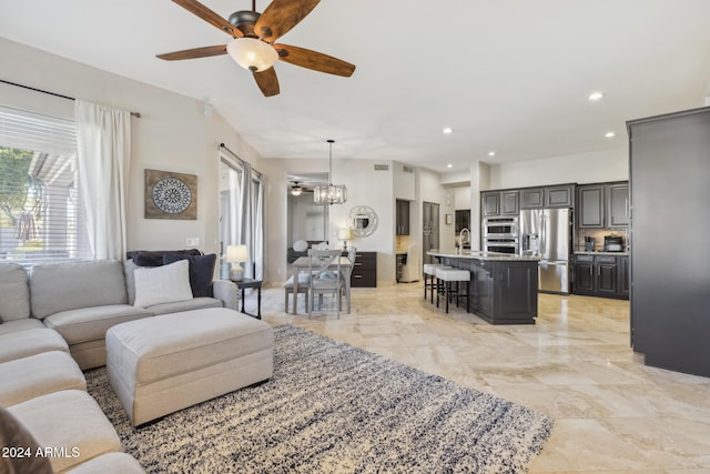 living room featuring ceiling fan and sink