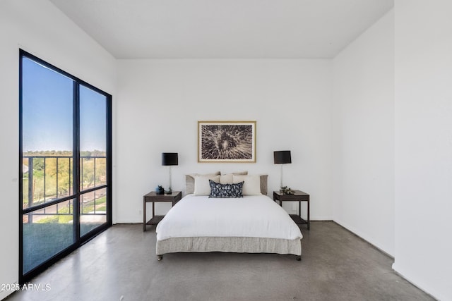 bedroom featuring baseboards and concrete floors