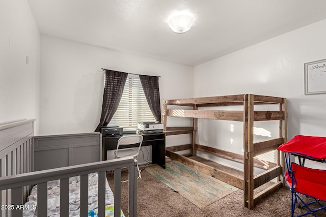 carpeted bedroom featuring wainscoting