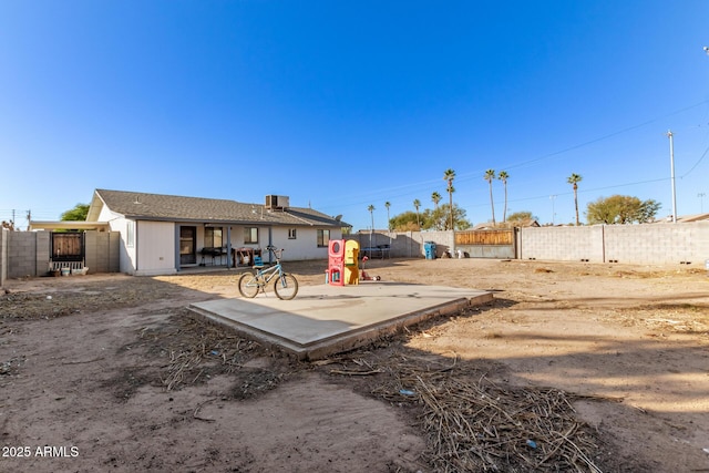 view of yard featuring a patio area, a fenced backyard, and central AC