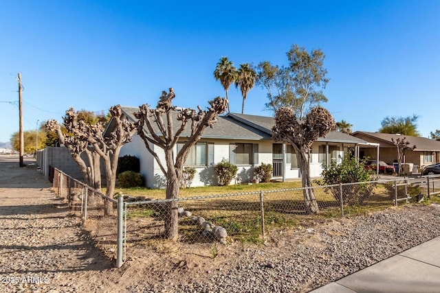 ranch-style house featuring a fenced front yard