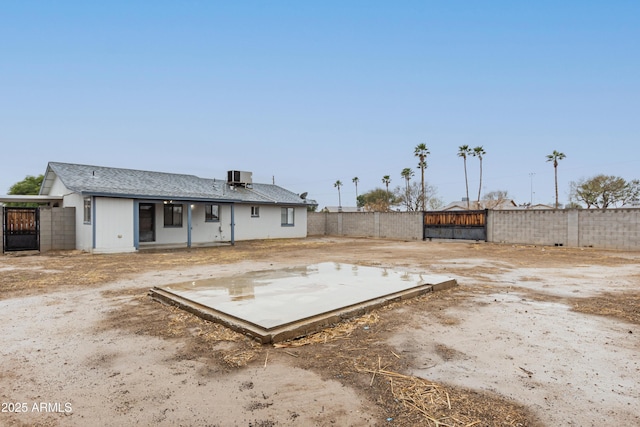 back of property featuring a patio area, a fenced backyard, and central AC