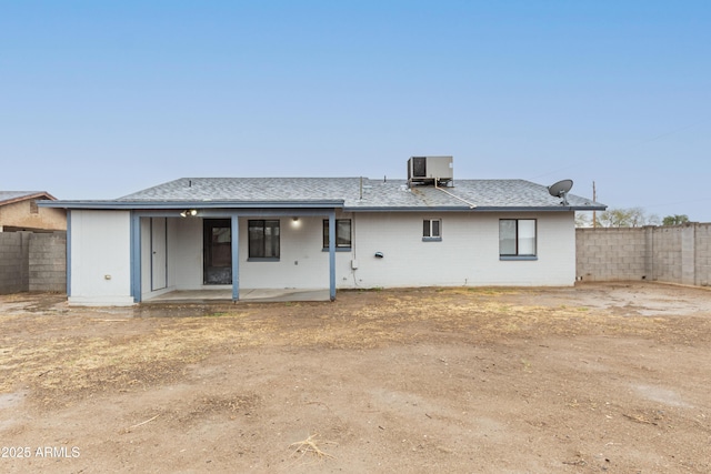 back of house with a patio, central AC, a fenced backyard, and roof with shingles