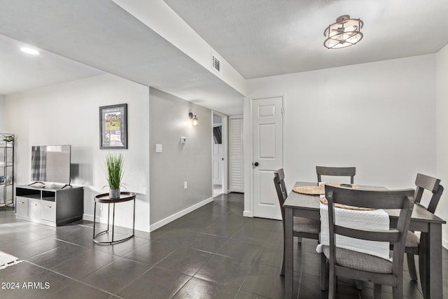 dining room featuring a textured ceiling