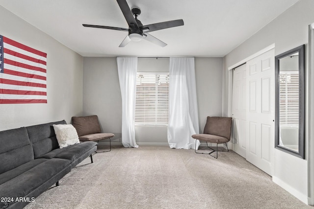 sitting room featuring ceiling fan and light colored carpet