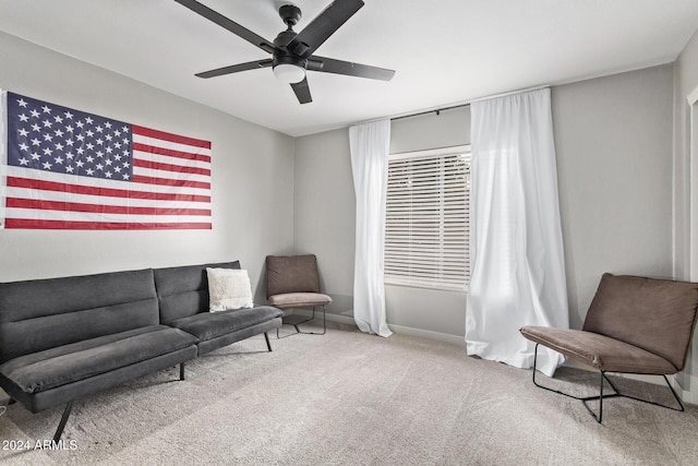 sitting room with ceiling fan and carpet floors