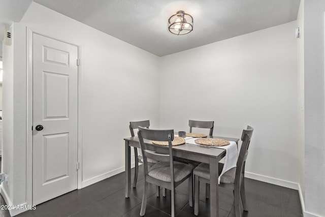 dining room featuring dark tile patterned flooring